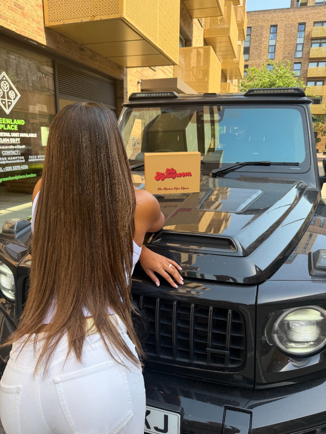 Sleek bronde lengths with the Honeyroom box on a G-Wagon